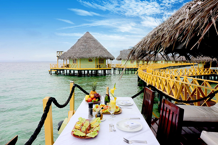 Eco-friendly floating hotel with a nice table decor full with tropical fruits and champagne