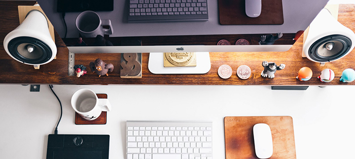 Clean desk with small figures and an empty cup of coffee