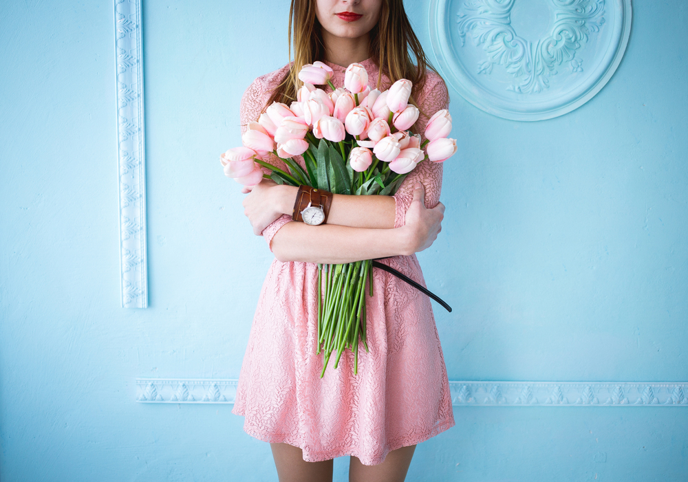 Girl in a dress holding roses