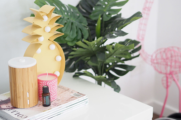 Wooden essential oil diffuser for home use with pink candle next to it