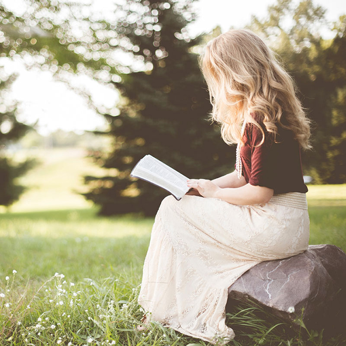 Girl reading outdoors