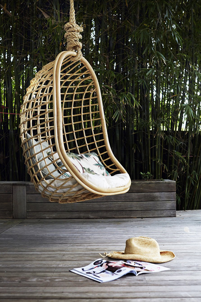 Hanging arch chair surrounded with calm nature