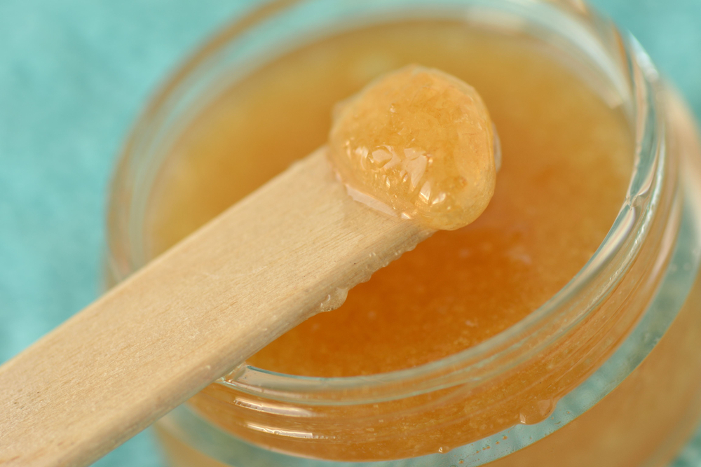 Honey in a jar with wooden spoon