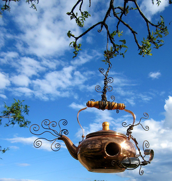 Kettle birdhouse hanging on a tree