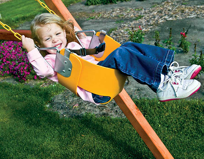 Happy girl on a bucket swing