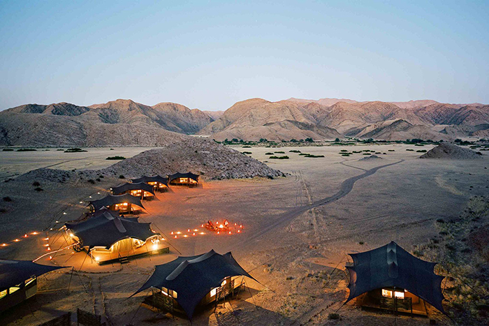 Guest houses in Namibia with cozy lights and small hills around 