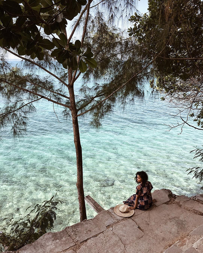 Woman sitting on a shore and enjoying the view