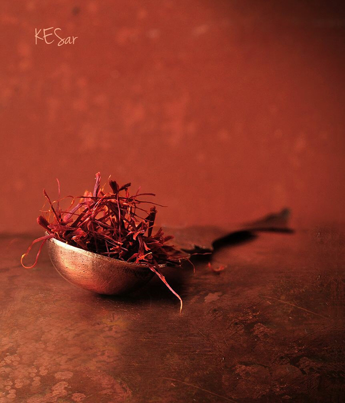 Dried saffron placed in a metal spoon