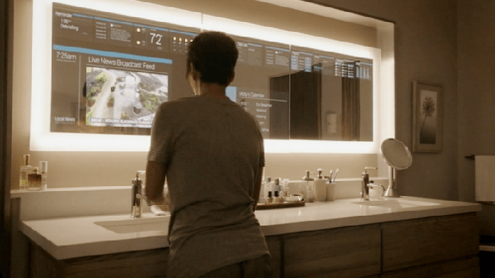 Woman washing her hands in a smart bathroom while watching the news