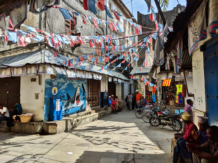 Tiny streets in Stone Town and people chatting