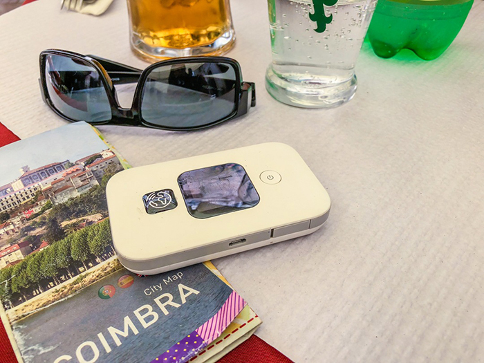 Portable WI FI Hot Spot, sunglasses and a City Map of Coimbra