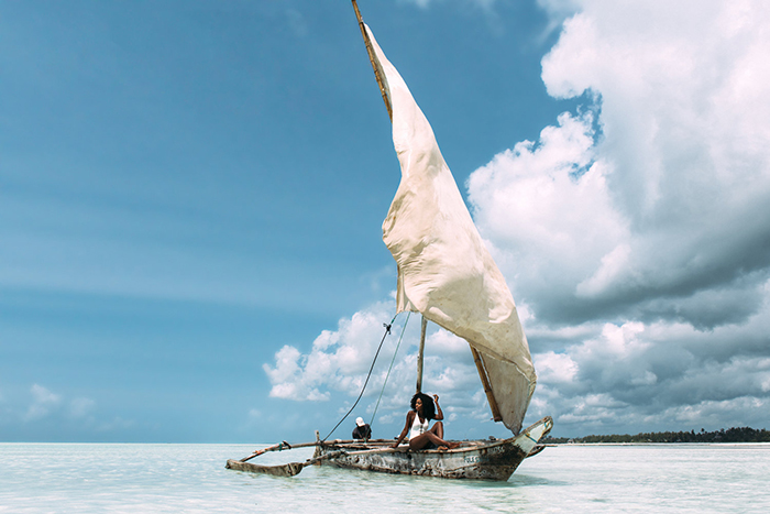 Woman enjoying the sun on a wooden boat 