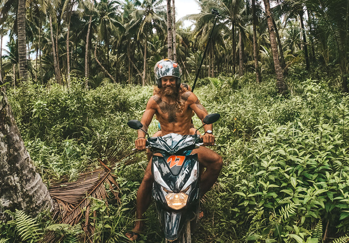 Couple on a motorbike around the forests on a budget travel