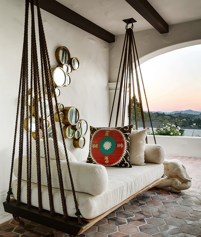 Vintage wooden porch swing on a balcony with a nice view on nature