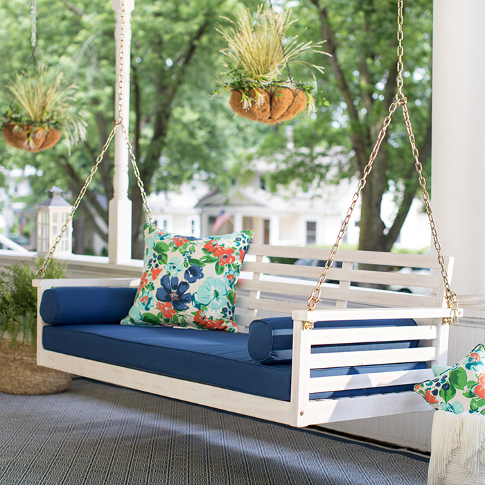 Wooden porch swing with floral cushions