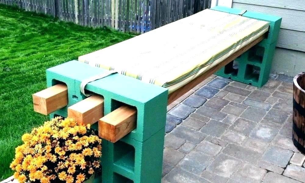 Bench made of bricks and a flower next to it