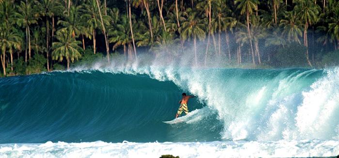 Surfing on big waves in Indonesia