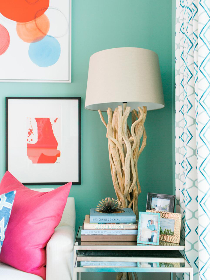 Coastal lamp in the corner with picture frames and books in front of it