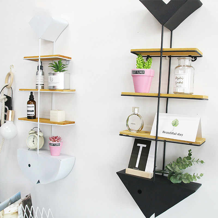 Fishbone shelf with perfumes and flowers on it