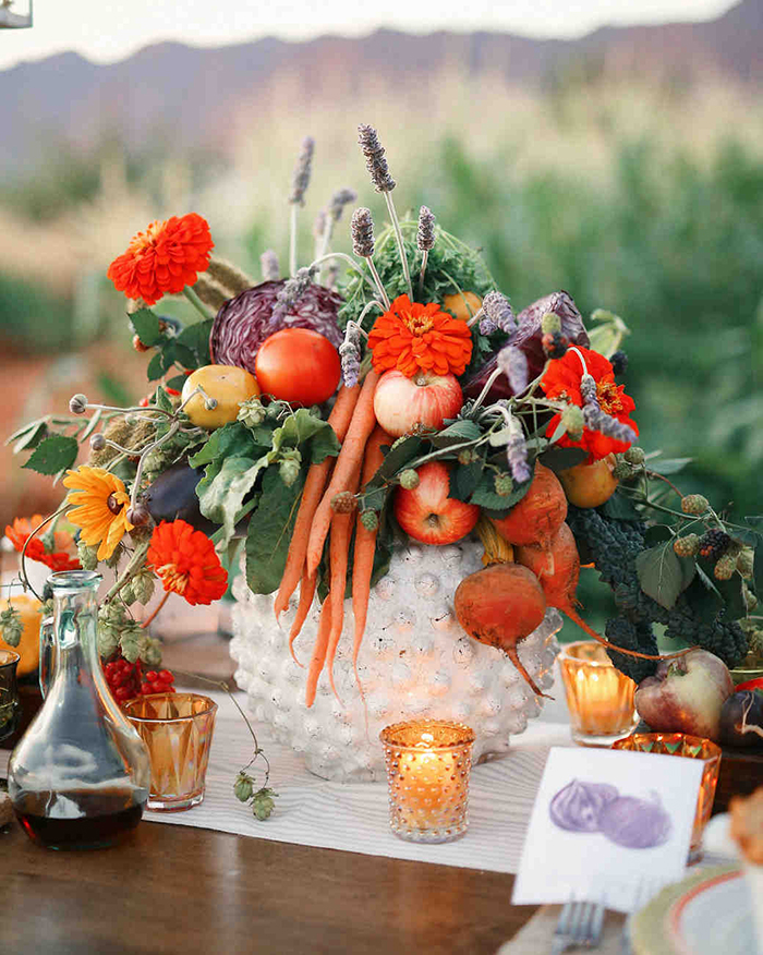 Fruits put in a big basket and surrounded with candles