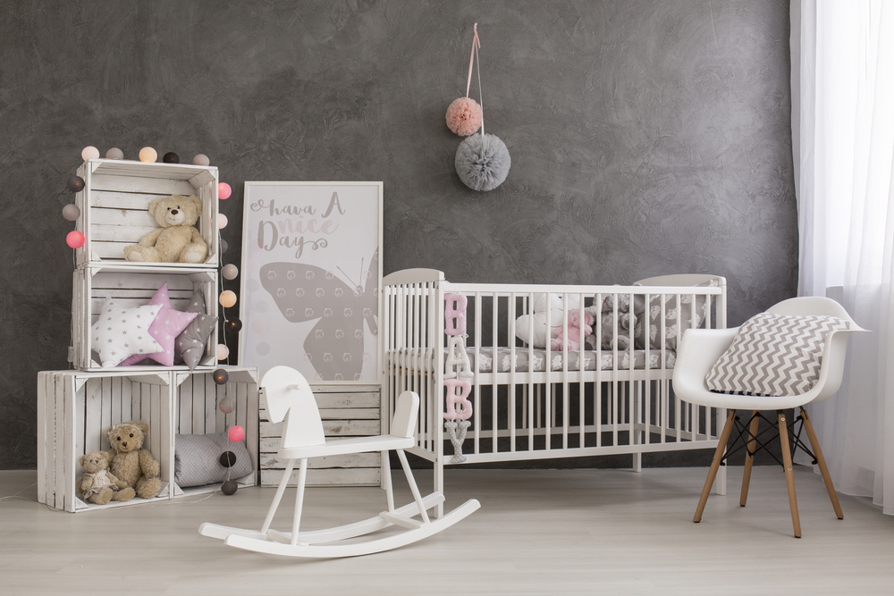 Nursery room in grey shades with cute furnitures in white