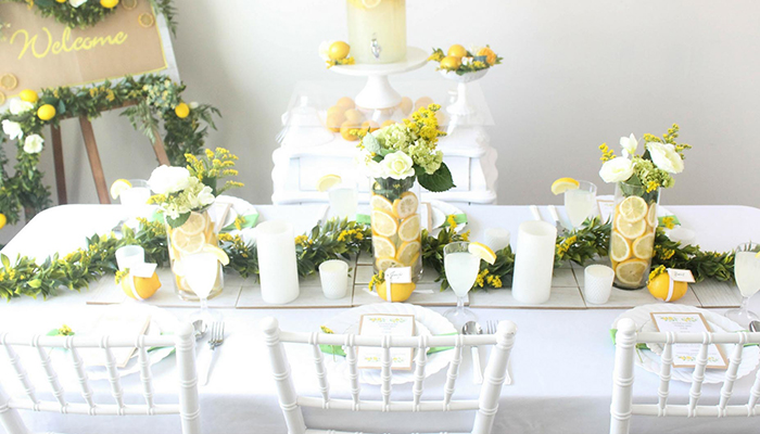 Lemon and flowers filled vases as a wedding table decor