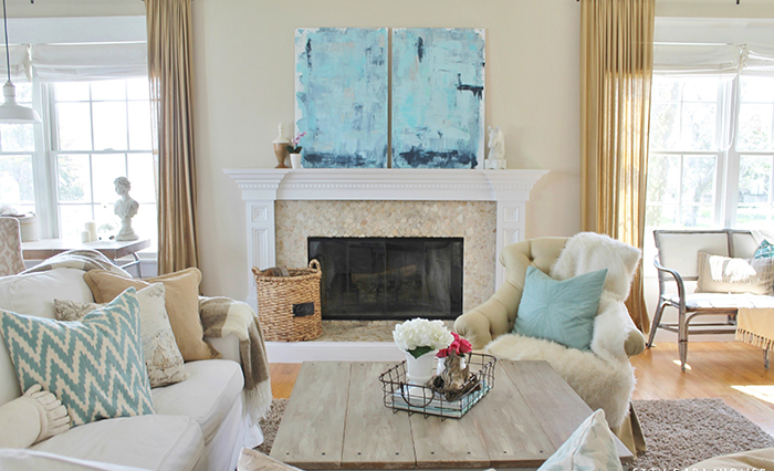 Coastal living room with a wooden table in the middle and flowers on it