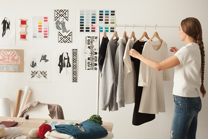 Woman arranging her clothes on a hanger