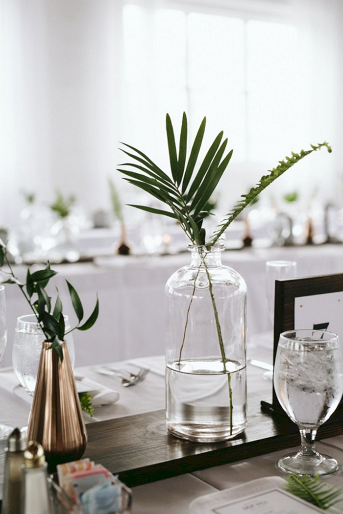 Minimalist table decor with vases filled with leave flowers