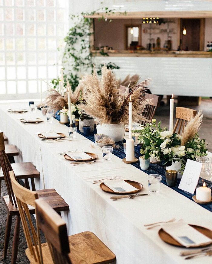 Pampas grass, candles and flowers on the wedding table