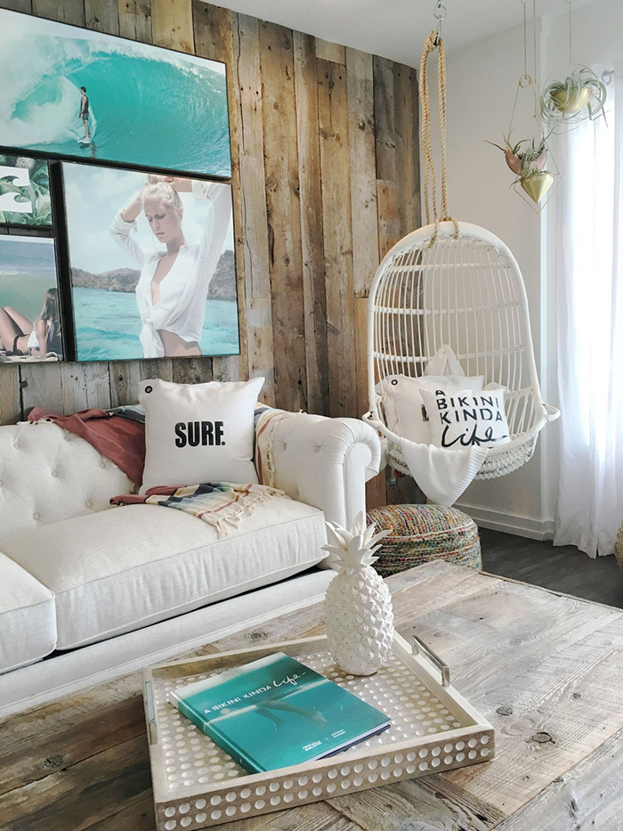 Rustic coastal living room with picture hanging on a wooden wall