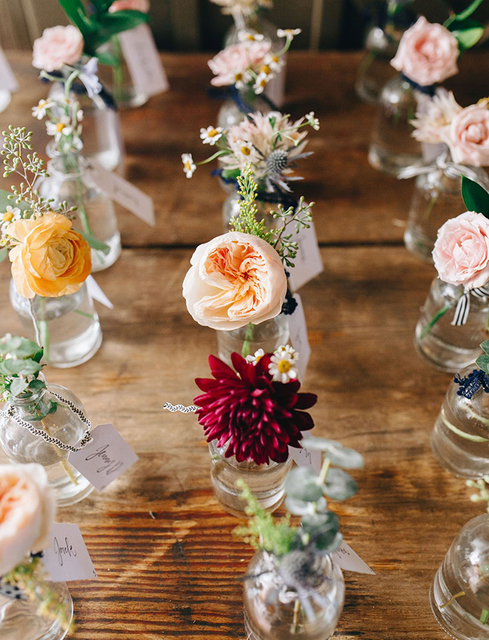 Summer wedding look with flowers put in bottles