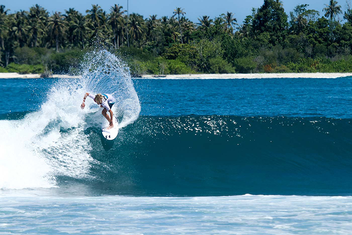 Woman surfing at Mentawai Islands