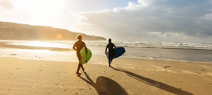 Two men with surfing desk on the beach