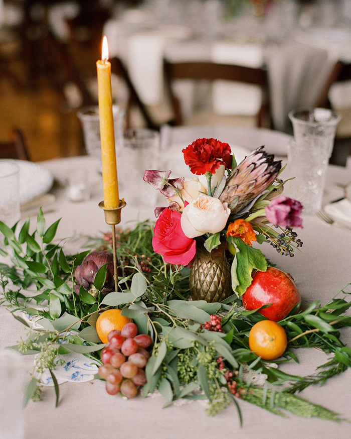 Fruits, flowers and a candle as wedding table decor