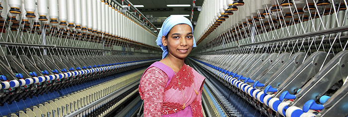 Afro american woman standing in front of many empty hangers