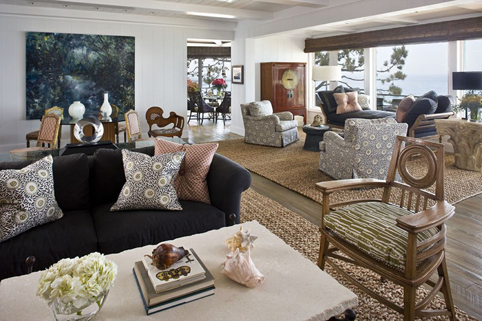 Huge living room decorated with nice natural rugs and cozy cushions on the sofas