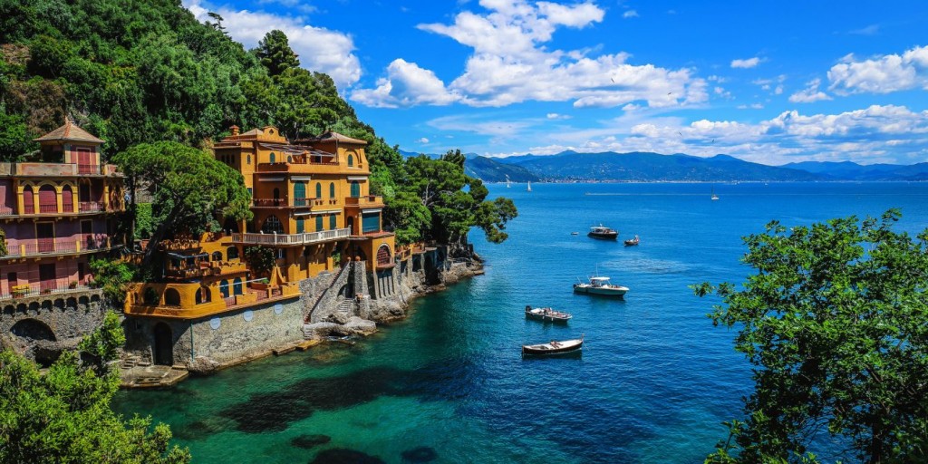 Cute houses on the sea and boats rowing on it