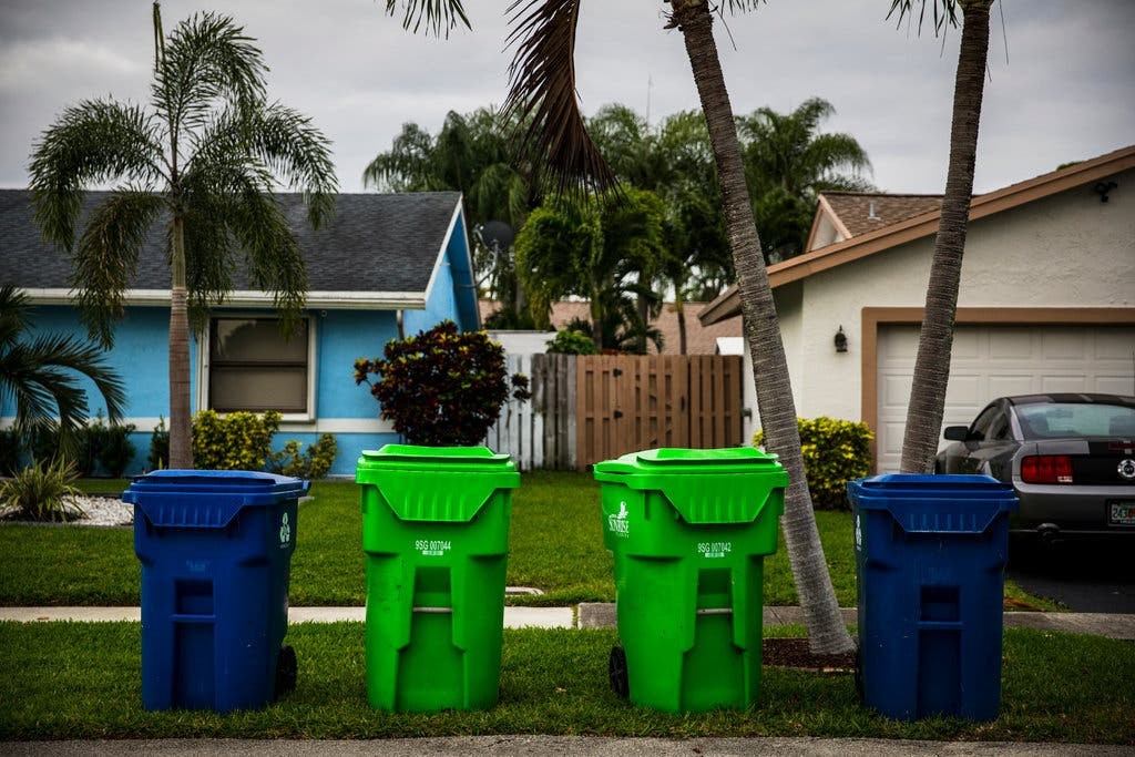 Recycling bins in front of a house