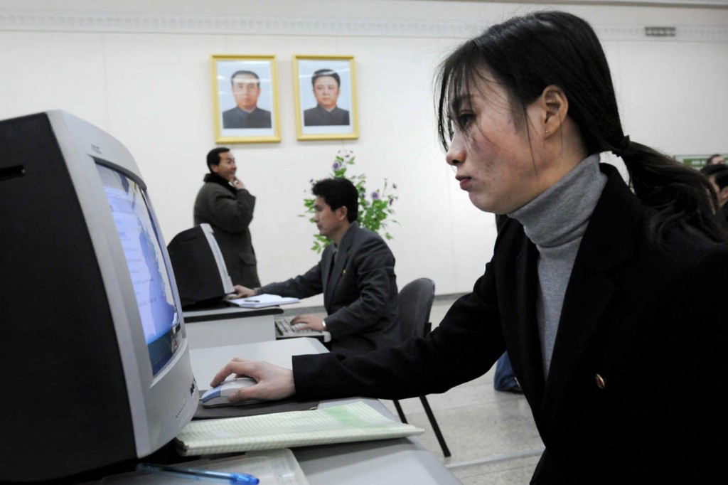 Woman and a man using computers in North Korea