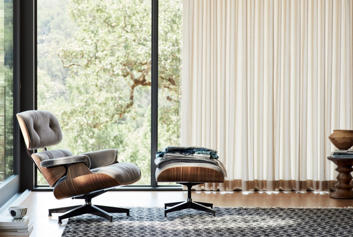 Reading chairs in a modern living room with glass windows