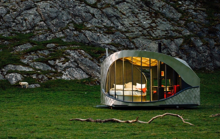 Luxury camping in a meadow with rocks behind