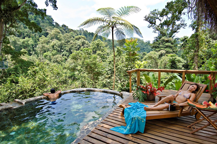 A couple resting in front of the pool in Costa Rica