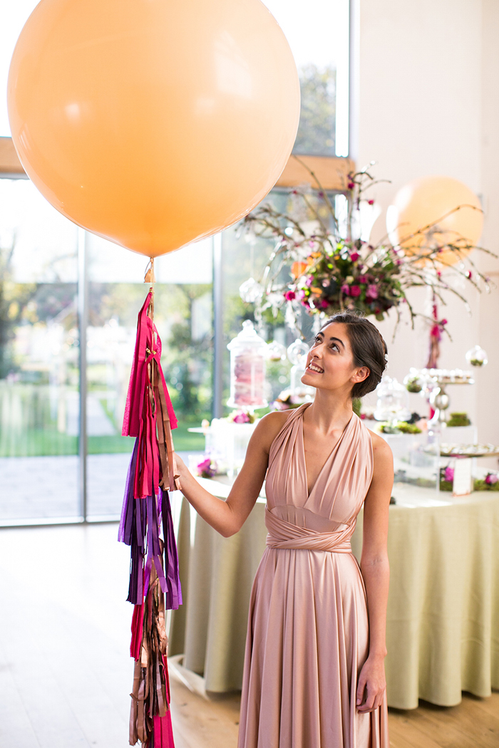 Woman in a dress holding a big balloon