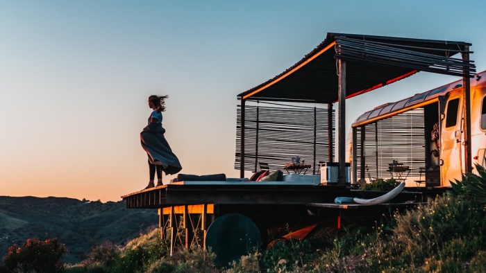 Man enjoying a nice view in front of his glamping spot