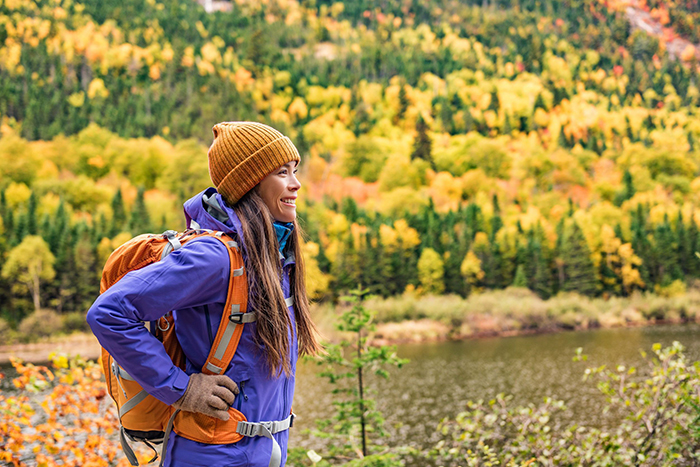 Woman hiking with a backpack on an autumn day