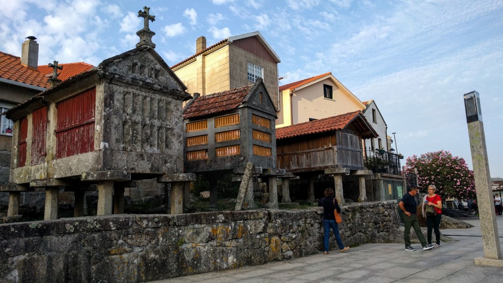 Small houses of Combarro and persons walking in front of them