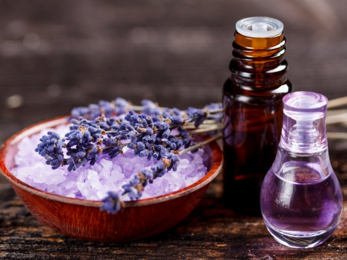 Lavender oil in a bottle and the flower itself