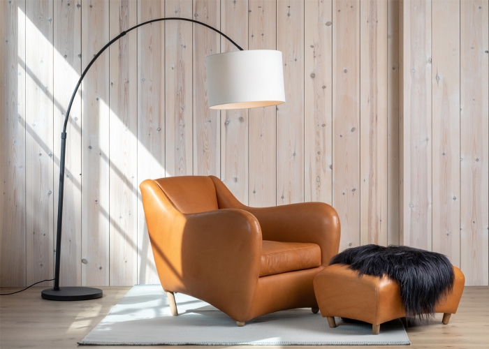 leather chair and a foot stool with a modern lamp