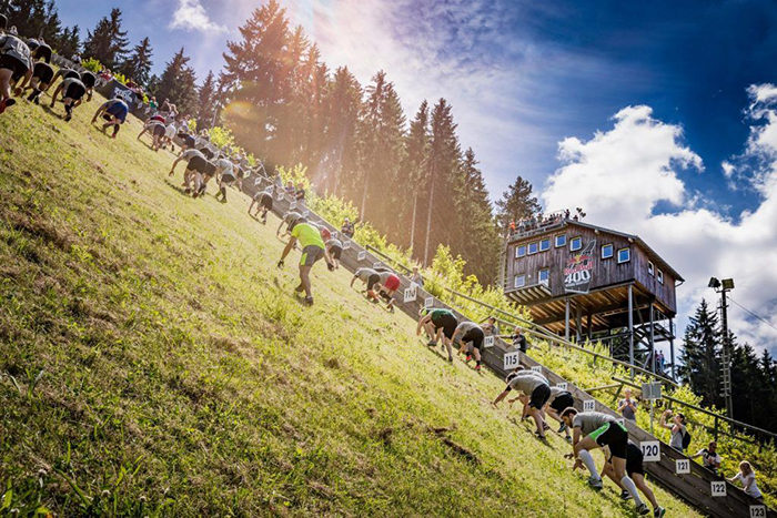 People climbing on a ski trail during summer